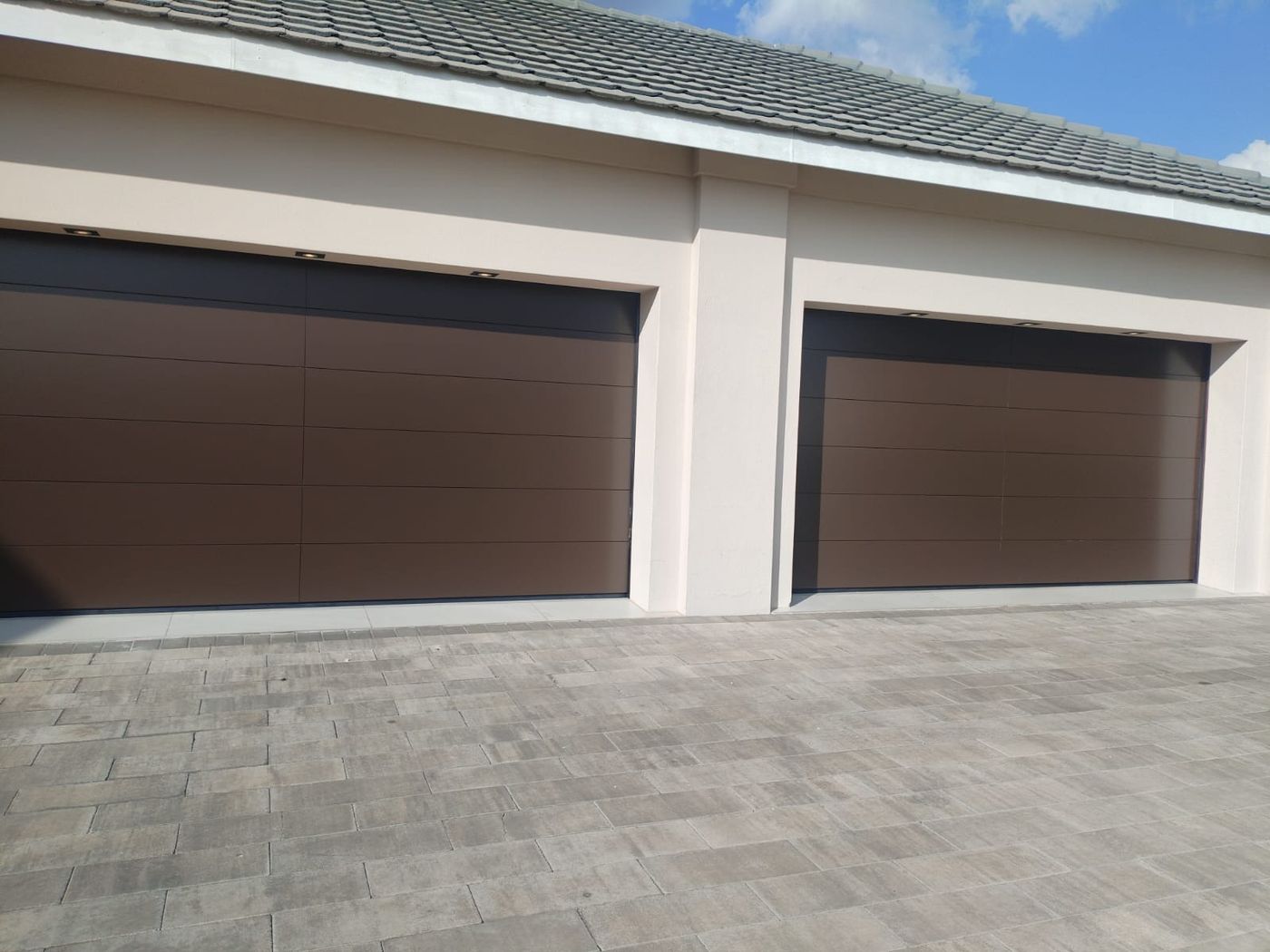 Bronze flush-panel garage doors, recent installation