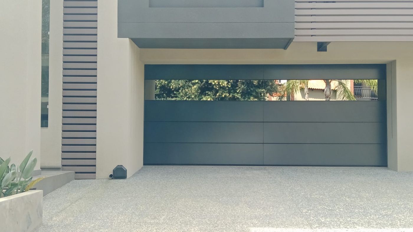 Modern charcoal garage door with slatted surround