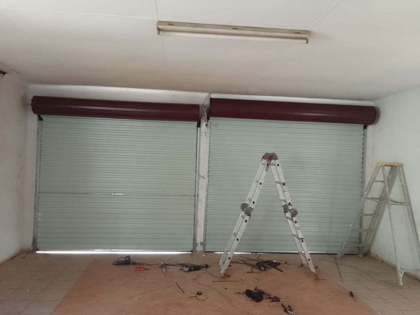 Focus Security Services technician repairing roller garage doors on site